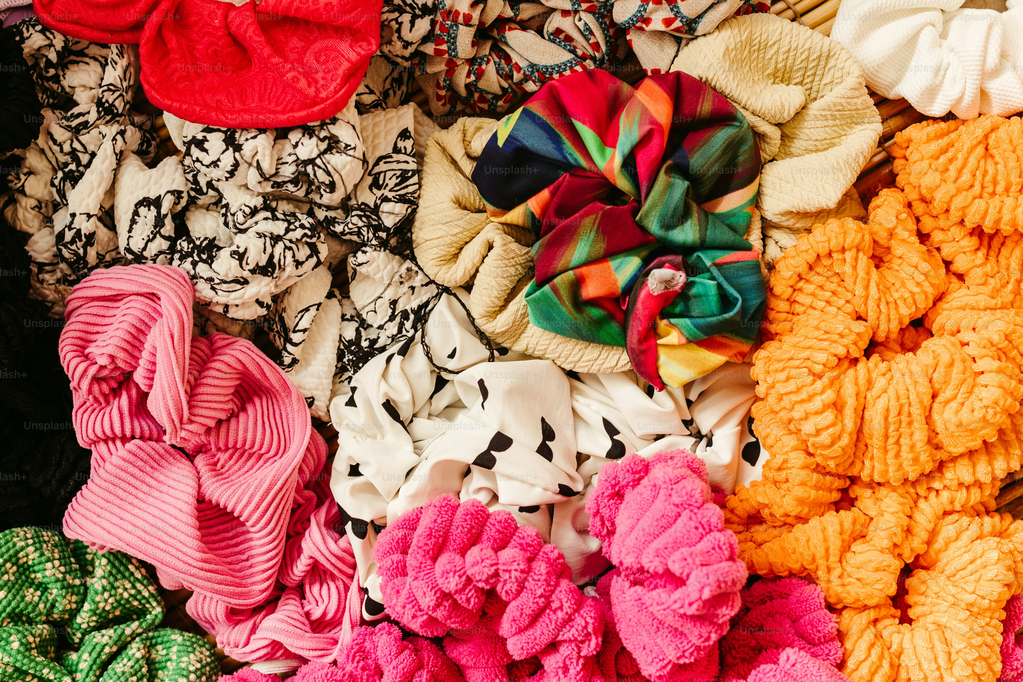 a pile of different colored hair scrunffs